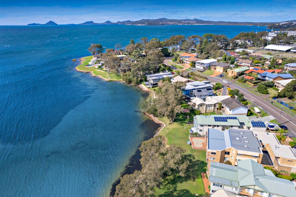 Aerial view of waterfront houses and shoreline near Woody’s Place in Soldiers Point, Port Stephens