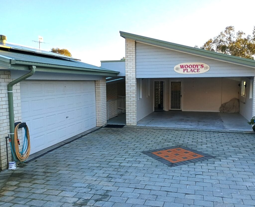 Driveway entrance with signage and bins outside Woody’s Place in Lake Macquarie